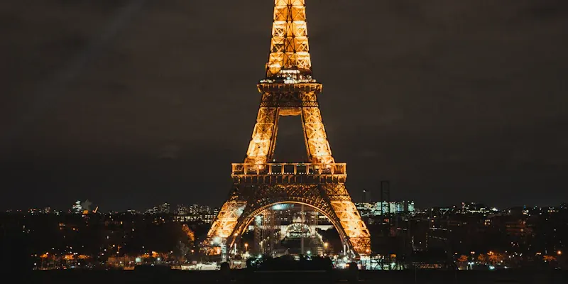 Eiffel Tower lit up at night in Paris